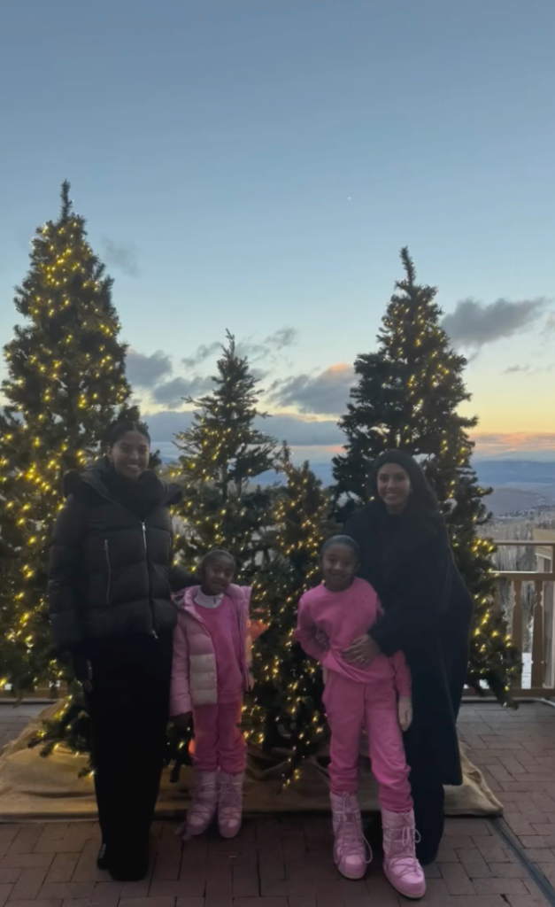 Vanessa Bryant and her three daughters stand in front of three Christmas trees in a holiday photo posted on Instagram 